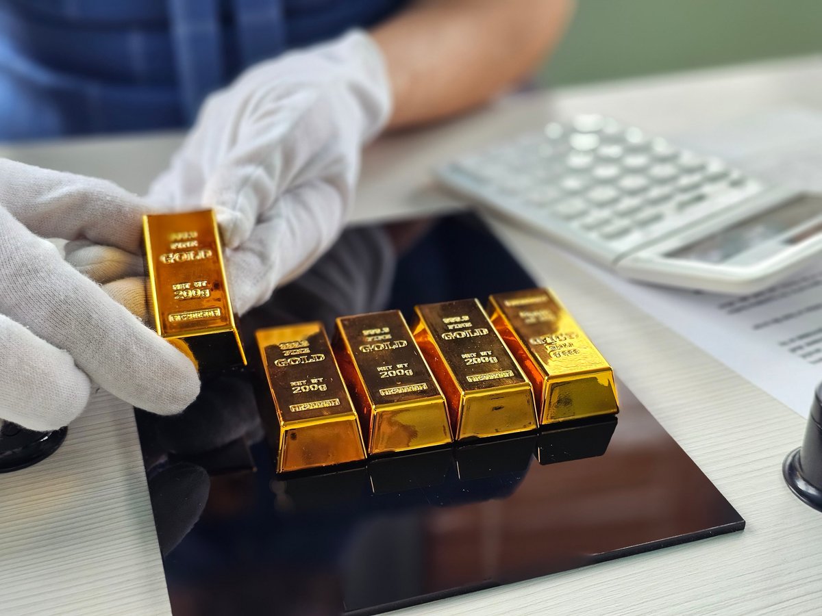 Gold bars being weighed and assessed at a financial facility