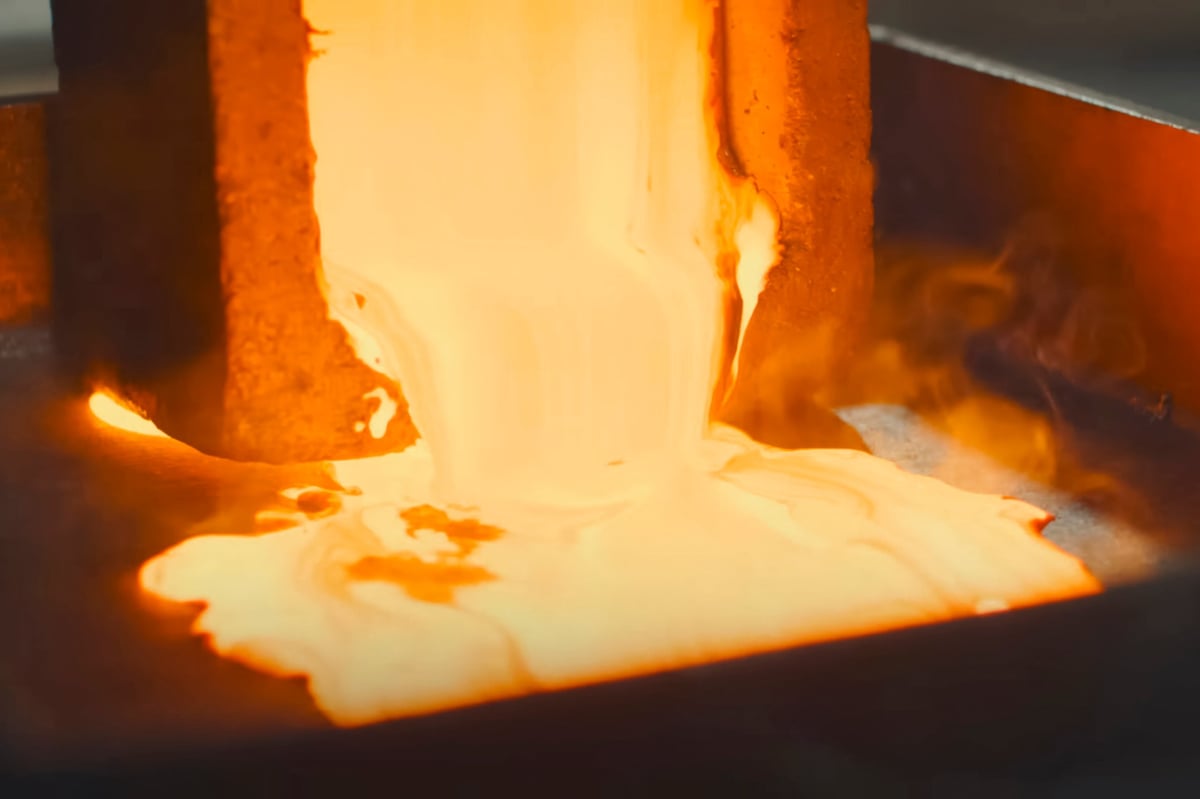 Molten gold pours out of the mold